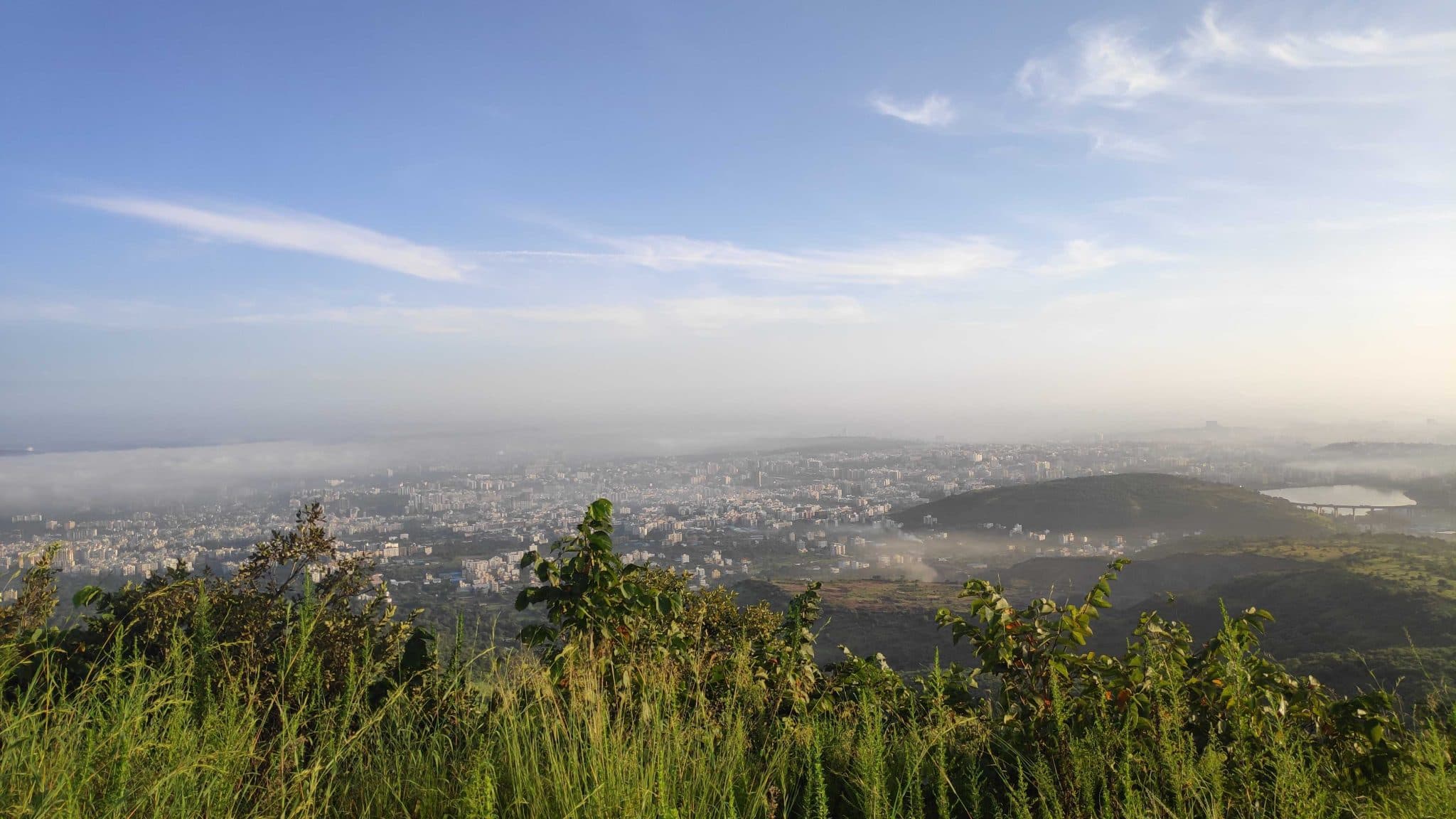Pune seen from a hill at dawn, mist over the city